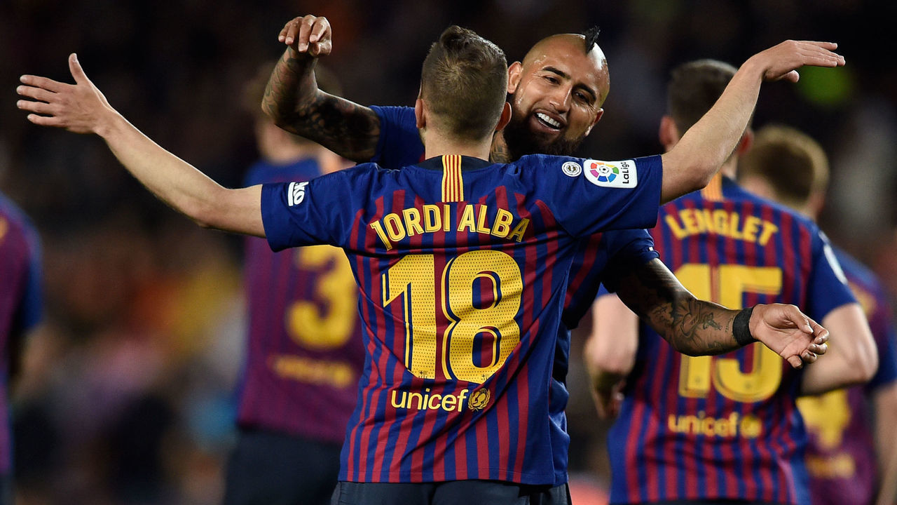 Barcelona's Spanish defender Jordi Alba celebrates scoring his team's second goal with Barcelona's Chilean midfielder Arturo Vidal during the Spanish league football match between FC Barcelona and Real Sociedad at the Camp Nou stadium in Barcelona on April 20, 2019.
