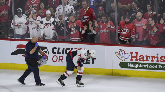 RALEIGH, NC - APRIL 18: Washington Capitals right wing T.J. Oshie (77) is escorted off the ice after getting injured on a hit by Carolina Hurricanes left wing Warren Foegele (13) during the third period of Game Four of the first round of the Stanley Cup Playoffs between the Washington Capitals and the Carolina Hurricanes on Thursday, April 18, 2019. The Carolina Hurricanes defeated the Washington Capitals 2-1 to tie the series 2-2.