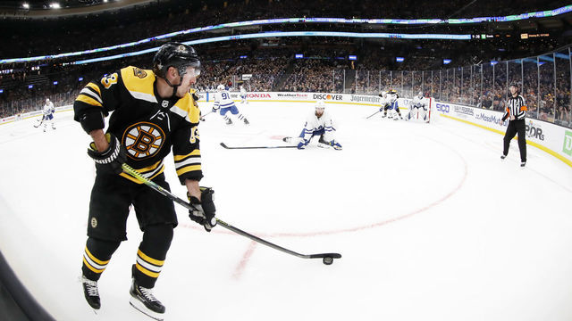 BOSTON, MA - APRIL 11: Boston Bruins left wing Brad Marchand (63) holds the puck along the boards during Game 1 of the First Round between the Boston Bruins and the Toronto Maple Leafs on April 11, 2019, at TD Garden in Boston, Massachusetts.