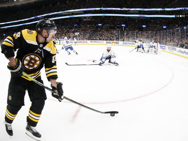 BOSTON, MA - APRIL 11: Boston Bruins left wing Brad Marchand (63) holds the puck along the boards during Game 1 of the First Round between the Boston Bruins and the Toronto Maple Leafs on April 11, 2019, at TD Garden in Boston, Massachusetts.