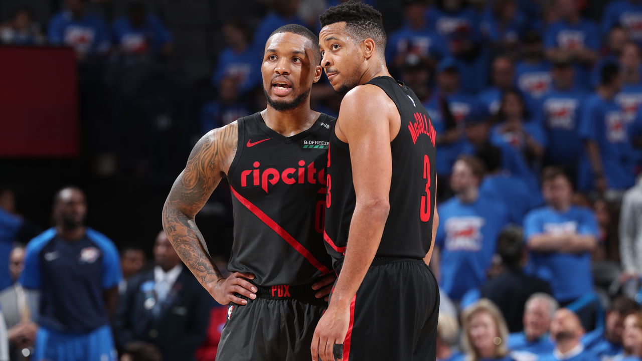 OKLAHOMA CITY, OK - APRIL 21: Damian Lillard #0 and CJ McCollum #3 of the Portland Trail Blazers look on during Game Four of Round One of the 2019 NBA Playoffs on April 21, 2019 at Chesapeake Energy Arena in Oklahoma City, Oklahoma. NOTE TO USER: User expressly acknowledges and agrees that, by downloading and/or using this photograph, user is consenting to the terms and conditions of the Getty Images License Agreement. Mandatory Copyright Notice: Copyright 2019 NBAE