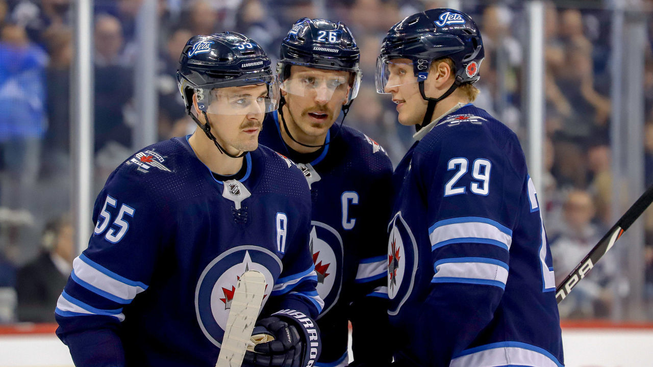 WINNIPEG, MB - NOVEMBER 9: Mark Scheifele #55, Blake Wheeler #26 and Patrik Laine #29 of the Winnipeg Jets discuss strategy during a second period stoppage in play against the Colorado Avalanche at the Bell MTS Place on November 9, 2018 in Winnipeg, Manitoba, Canada.
