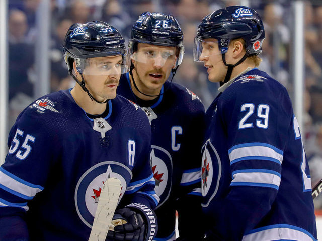 WINNIPEG, MB - NOVEMBER 9: Mark Scheifele #55, Blake Wheeler #26 and Patrik Laine #29 of the Winnipeg Jets discuss strategy during a second period stoppage in play against the Colorado Avalanche at the Bell MTS Place on November 9, 2018 in Winnipeg, Manitoba, Canada.