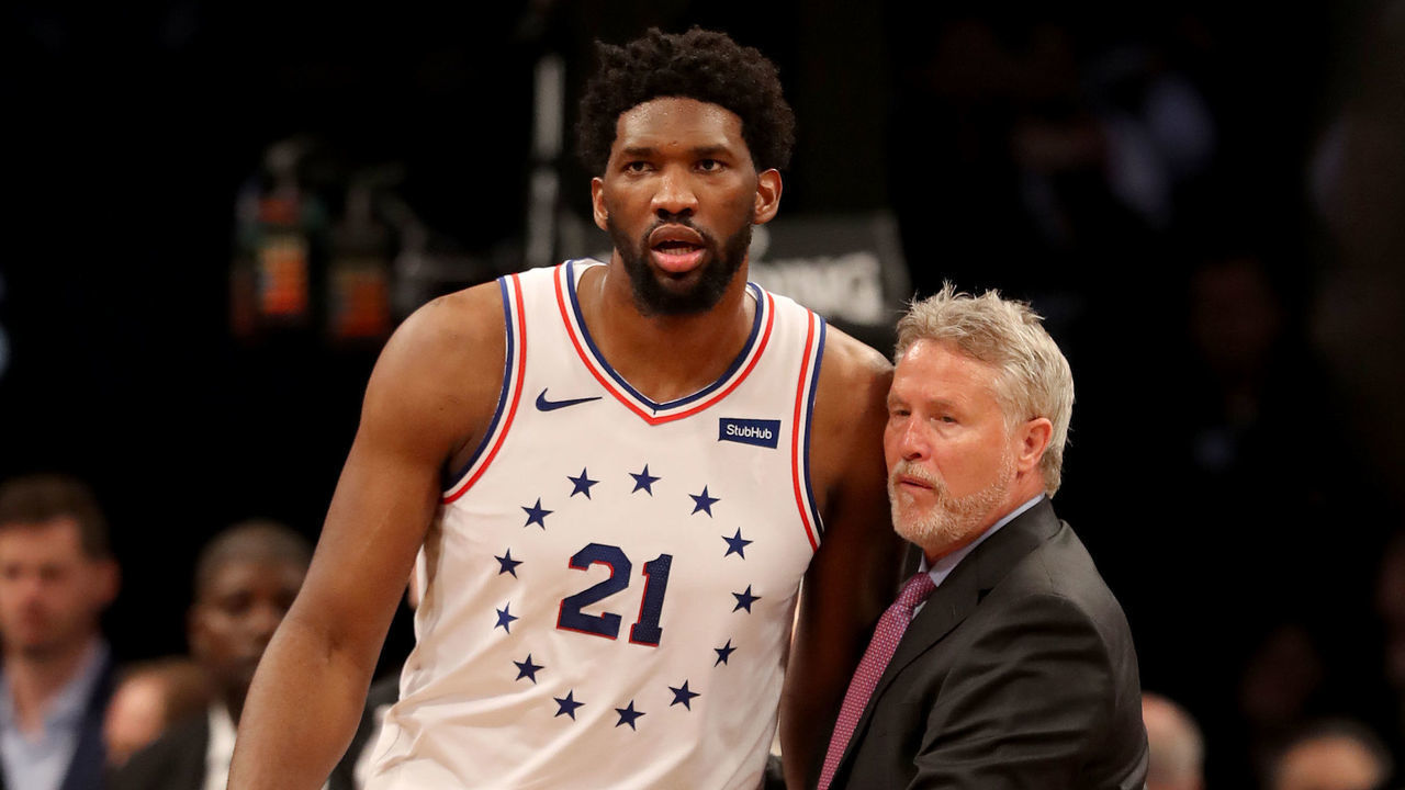 NEW YORK, NEW YORK - APRIL 20: Head coach Brett Brown of the Philadelphia 76ers holds back his player Joel Embiid #21 after a scuffle between Brooklyn Nets and Philadelphia 76ers players in the third quarter at Barclays Center on April 20, 2019 in the Brooklyn borough of New York City.The Philadelphia 76ers defeated the Brooklyn Nets 112-108.