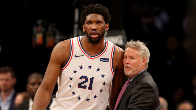 NEW YORK, NEW YORK - APRIL 20: Head coach Brett Brown of the Philadelphia 76ers holds back his player Joel Embiid #21 after a scuffle between Brooklyn Nets and Philadelphia 76ers players in the third quarter at Barclays Center on April 20, 2019 in the Brooklyn borough of New York City.The Philadelphia 76ers defeated the Brooklyn Nets 112-108.