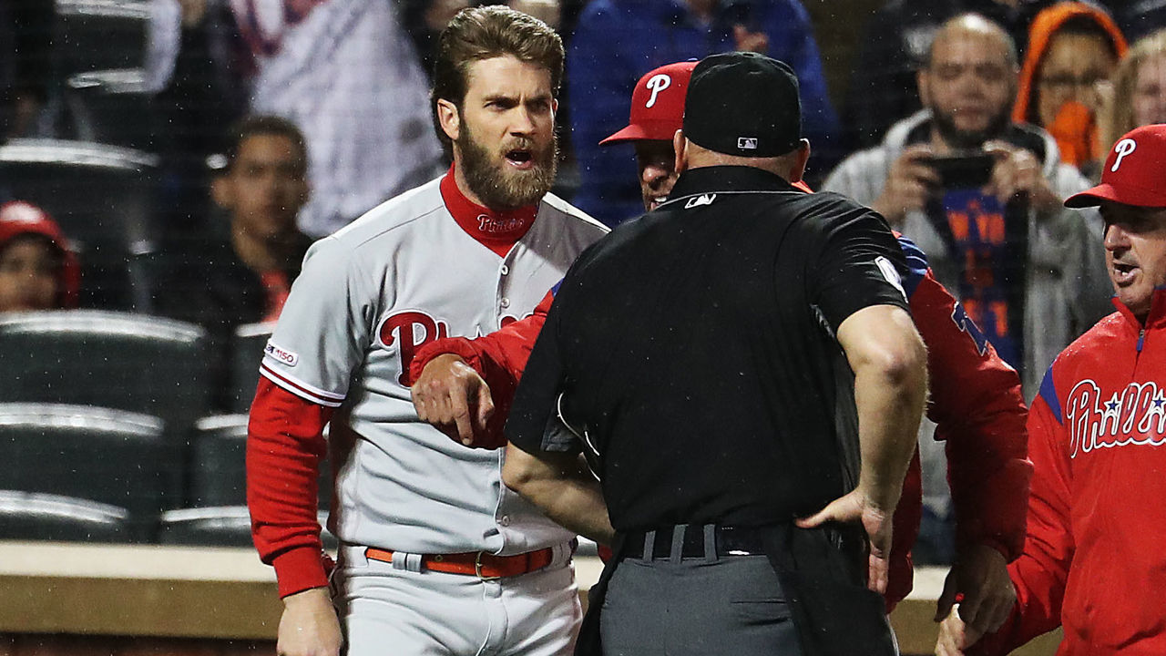 NEW YORK, NEW YORK - APRIL 22: Bryce Harper #3 of the Philadelphia Phillies is ejected by home plate umpire Mark Carlson during their game against the New York Mets at Citi Field on April 22, 2019 in New York City.