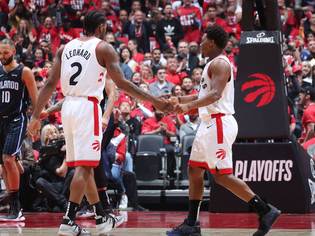 TORONTO, CANADA - APRIL 23: Kawhi Leonard #2, and Kyle Lowry #7 of the Toronto Raptors hi-five each other during Game Five of Round One of the 2019 NBA Playoffs against the Orlando Magic on April 23, 2019 at the Scotiabank Arena in Toronto, Ontario, Canada. Mandatory Copyright Notice: Copyright 2019 NBAE