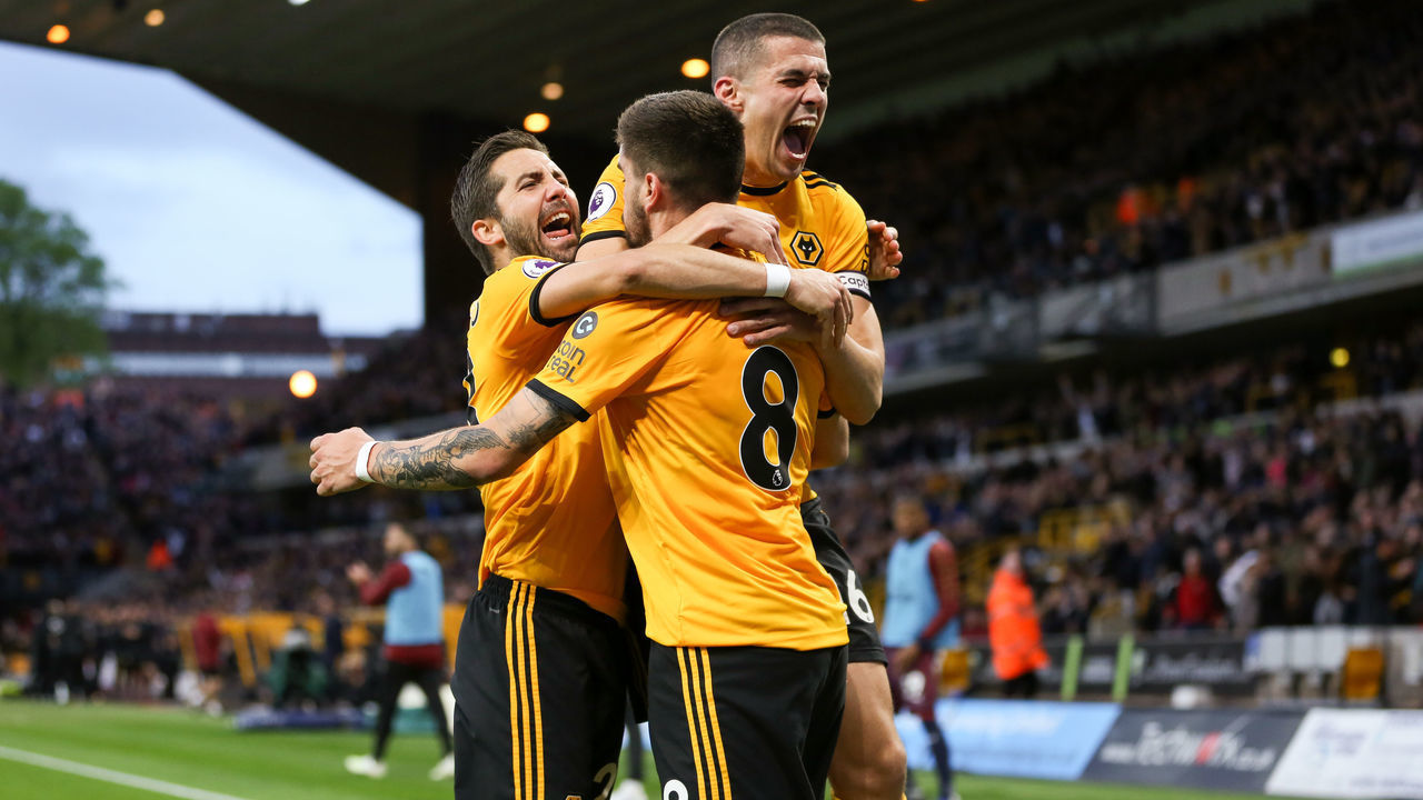 WOLVERHAMPTON, ENGLAND - APRIL 24: Ruben Neves of Wolverhampton Wanderers celebrates with team mates Conor Coady of Wolverhampton Wanderers and Joao Moutinho of Wolverhampton Wanderers after scoring a goal to make it 1-0 during the Premier League match between Wolverhampton Wanderers and Arsenal FC at Molineux on April 24, 2019 in Wolverhampton, United Kingdom.