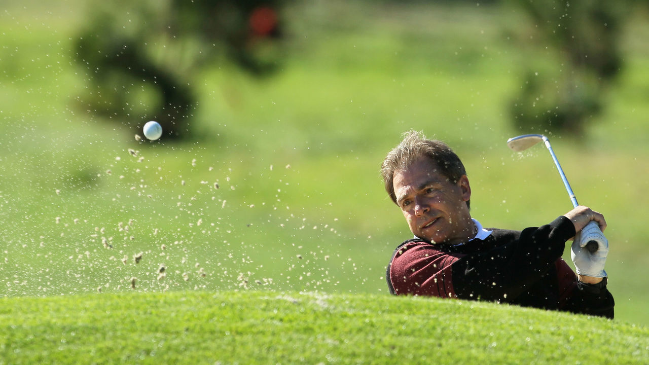 PEBBLE BEACH, CA - FEBRUARY 09: Alabama Crimson Tide head coach Nick Saban hits a bunker shot on the tenth hole during the first round of the AT&T Pebble Beach National Pro-Am at the Spyglass Hill Golf Course on February 9, 2012 in Pebble Beach, California.