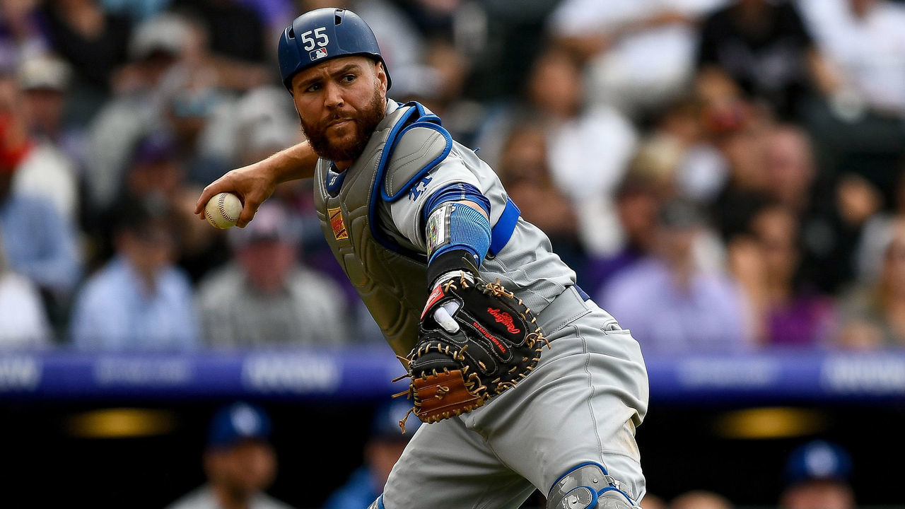 DENVER, CO - APRIL 5: Russell Martin #55 of the Los Angeles Dodgers throws to first base against the Colorado Rockies after fielding a sixth inning bunt during the Colorado Rockies home opener at Coors Field on April 5, 2019 in Denver, Colorado.