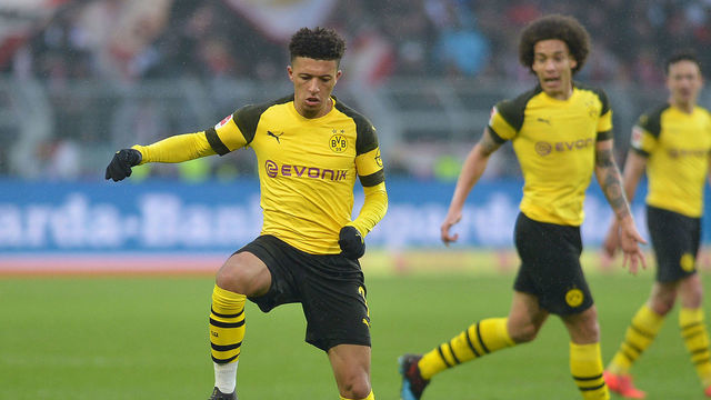 DORTMUND, GERMANY - APRIL 13: Jadon Sancho of Borussia Dortmund controls the ball, Axel Witsel of Borussia Dortmund looks on during the Bundesliga match between Borussia Dortmund and 1. FSV Mainz 05 at Signal Iduna Park on April 13, 2019 in Dortmund, Germany.