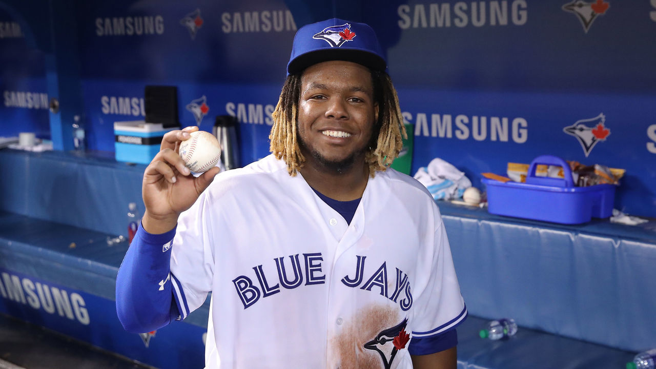 TORONTO, ON - APRIL 26: Vladimir Guerrero Jr. #27 of the Toronto Blue Jays holds the baseball he hit for his first MLB career hit during MLB game action against the Oakland Athletics at Rogers Centre on April 26, 2019 in Toronto, Canada.
