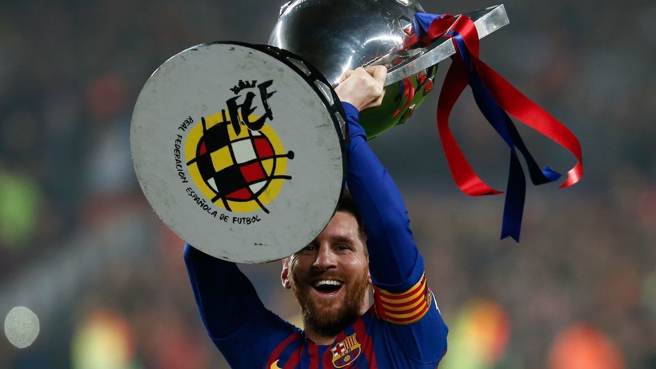 Barcelona's Argentinian forward Lionel Messi celebrates with the Liga trophy as Barcelona won their 26th league title after the Spanish League football match between Barcelona and Levante at the Camp Nou stadium in Barcelona on April 27, 2019.
