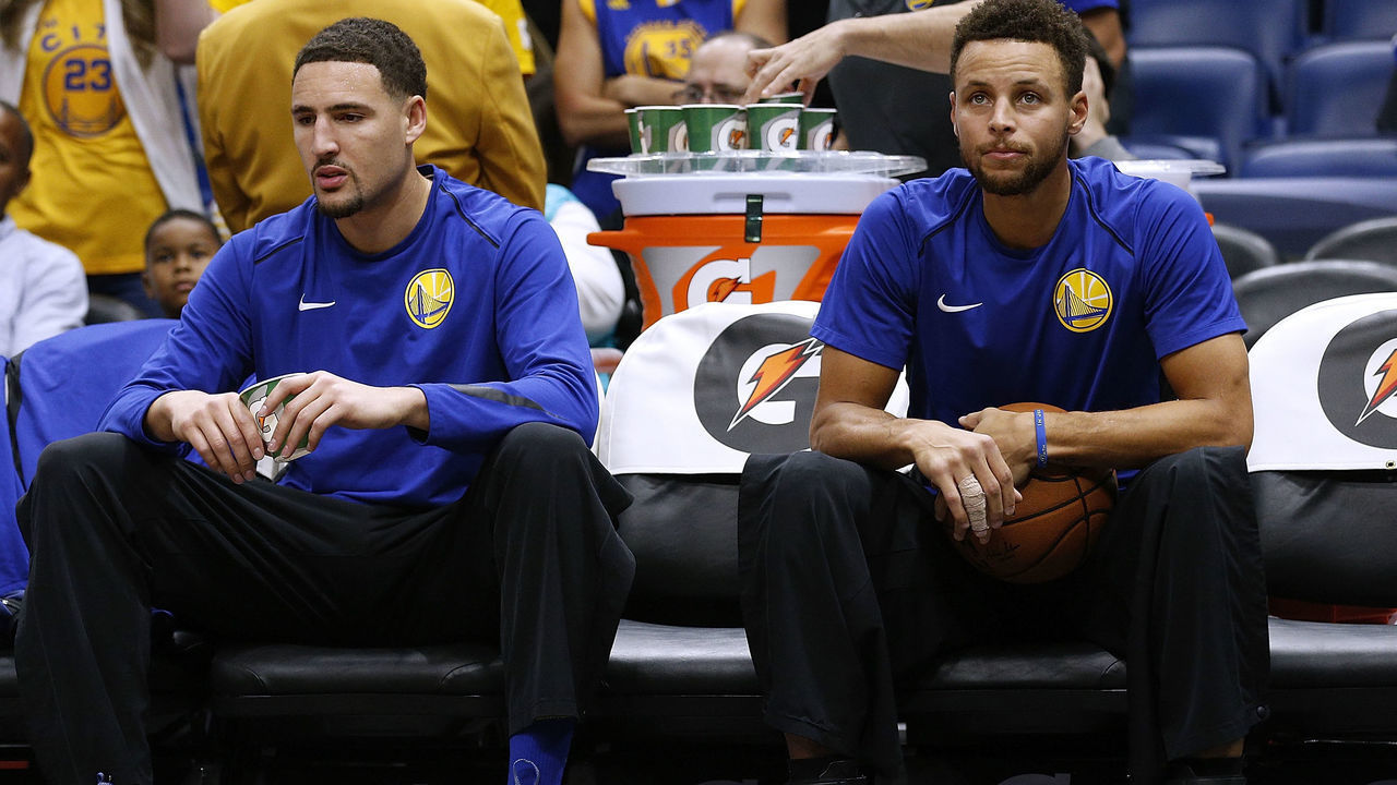 NEW ORLEANS, LA - DECEMBER 04: Stephen Curry #30 of the Golden State Warriors (R) and Klay Thompson #11 sit on the bench before a game against the New Orleans Pelicans at the Smoothie King Center on December 4, 2017 in New Orleans, Louisiana.