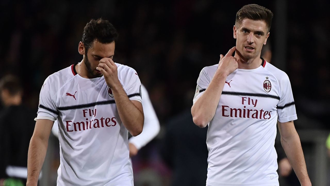 AC Milan's Turkish midfielder Hakan Chalhanoglu and AC Milan's Polish forward Krzysztof Piatek react at the end of the Italian Serie A football match between Torino and AC Milan on April 28, 2019, at the Grande Torino Stadium in Turin.