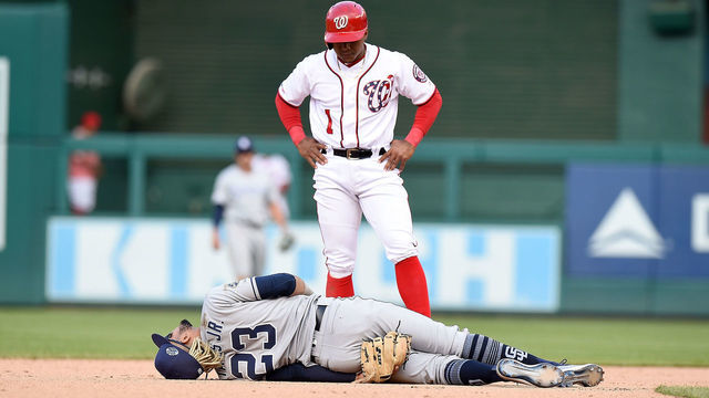 WASHINGTON, DC - APRIL 28: Wilmer Difo #1 of the Washington Nationals looks on as Fernando Tatis Jr. #23 of the San Diego Padres is injured on a play in the 10th inning at Nationals Park on April 28, 2019 in Washington, DC.