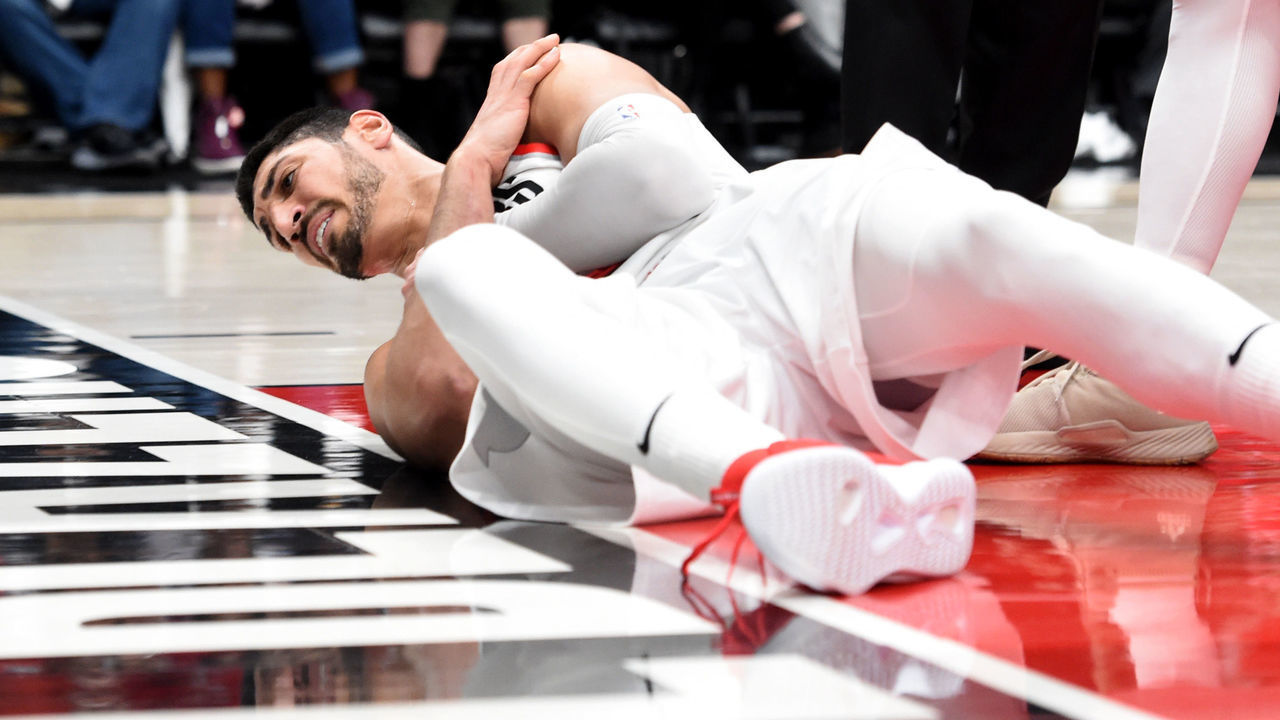 PORTLAND, OREGON - APRIL 23: Enes Kanter #00 of the Portland Trail Blazers holds his shoulder after being knocked to the floor during the second half of Game Five of the Western Conference quarterfinals against the Oklahoma City Thunder during the 2019 NBA Playoffs at Moda Center on April 23, 2019 in Portland, Oregon. The Blazers won 118-115.