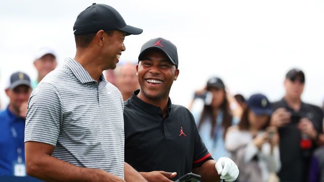 PONTE VEDRA BEACH, FLORIDA - MARCH 13: Tiger Woods of the United States and Harold Varner III of the United States walk during a practice round for The PLAYERS Championship on The Stadium Course at TPC Sawgrass on March 13, 2019 in Ponte Vedra Beach, Florida.