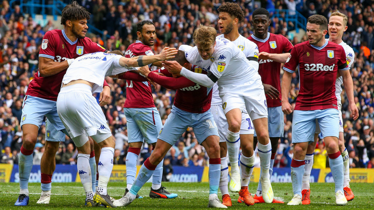 LEEDS, ENGLAND - APRIL 28: Leeds United's Patrick Bamford wrestles with Aston Villa's Conor Hourihane during the Sky Bet Championship match between Leeds United and Aston Villa at Elland Road on April 28, 2019 in Leeds, England.