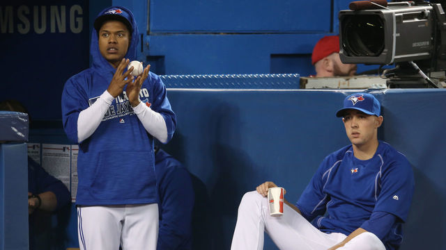 TORONTO, CANADA - APRIL 9: Marcus Stroman #6 of the Toronto Blue Jays and Aaron Sanchez #41 look on from the top step of the dugout during MLB game action against the Boston Red Sox on April 9, 2016 at Rogers Centre in Toronto, Ontario, Canada.