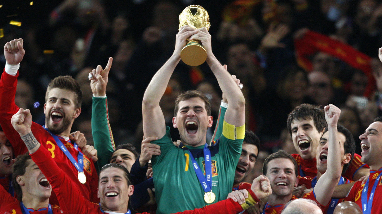 Spain captain and goalkeeper Iker Casillas lifts the world cup trophy and celebrates with teammates