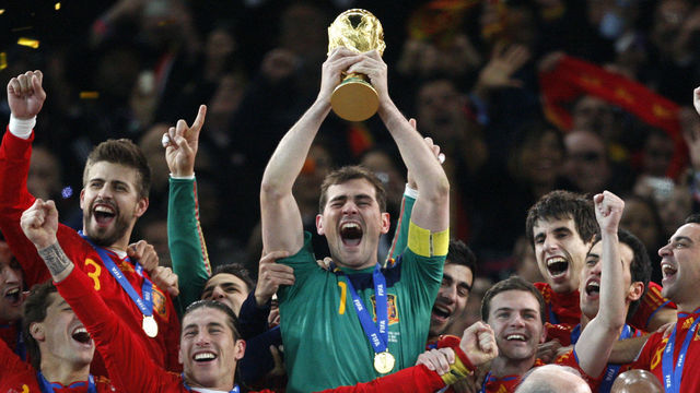 Spain captain and goalkeeper Iker Casillas lifts the world cup trophy and celebrates with teammates