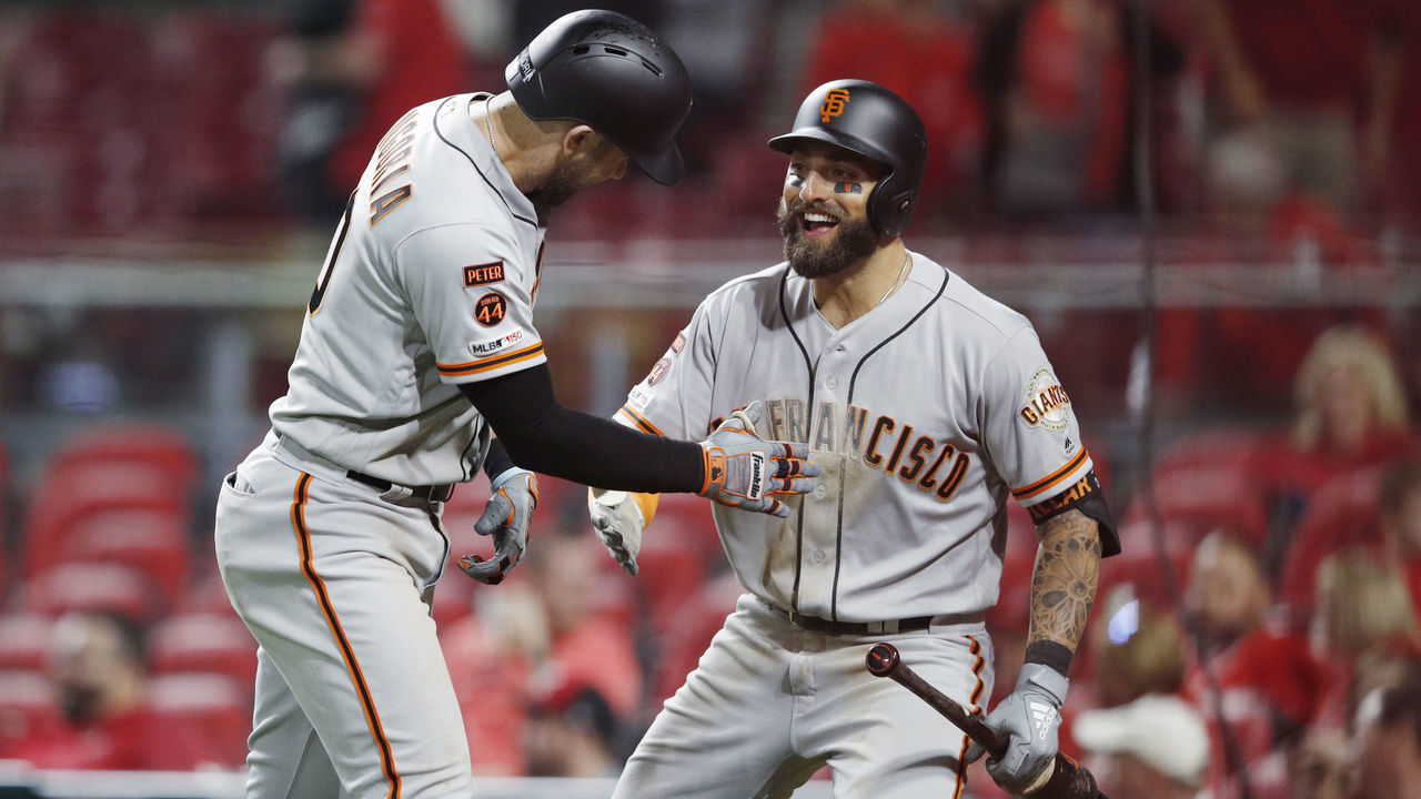 CINCINNATI, OH - MAY 03: Evan Longoria #10 of the San Francisco Giants celebrates with Kevin Pillar #1 after hitting a solo home run to break a tie game in the 11th inning against the Cincinnati Reds at Great American Ball Park on May 3, 2019 in Cincinnati, Ohio. The Giants won 12-11 in 11 innings.