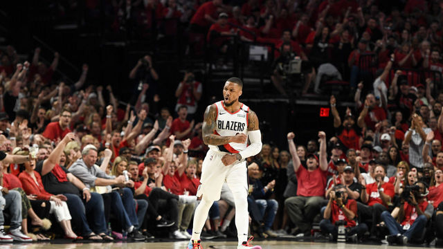 PORTLAND, OR - MAY 5: Damian Lillard (0) of the Portland Trail Blazers flexes after hitting a three while being fouled by Will Barton (5) of the Denver Nuggets during the first quarter on Sunday, May 5, 2019. The Denver Nuggets and the Portland Trail Blazers game four of their second round NBA playoff series at the Moda Center in Portland.