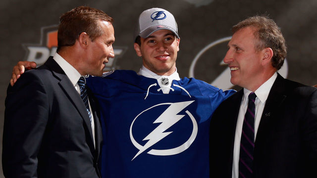 PHILADELPHIA, PA - JUNE 27: Anthony DeAngelo smiles as he stands with general manager Steve Yzerman (L) and assistant general manager Pat Verbeek (R) after being selected 19th overall by the Tampa Bay Lightning during the 2014 NHL Entry Draft at Wells Fargo Center on June 27, 2014 in Philadelphia, Pennsylvania.