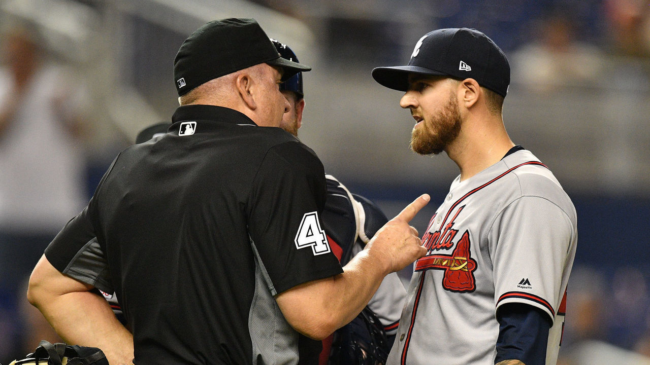 MIAMI, FL - MAY 03: Kevin Gausman #45 of the Atlanta Braves is ejected from the game by umpire Jeff Nelson #45 after throwing at Jose Urena #62 of the Miami Marlins in the second inning at Marlins Park on May 3, 2019 in Miami, Florida.