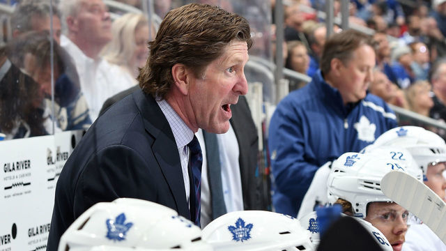 GLENDALE, AZ - FEBRUARY 16: Head coach Mike Babcock of the Toronto Maple Leafs watches from the bench against the Arizona Coyotes at Gila River Arena on February 16, 2019 in Glendale, Arizona.
