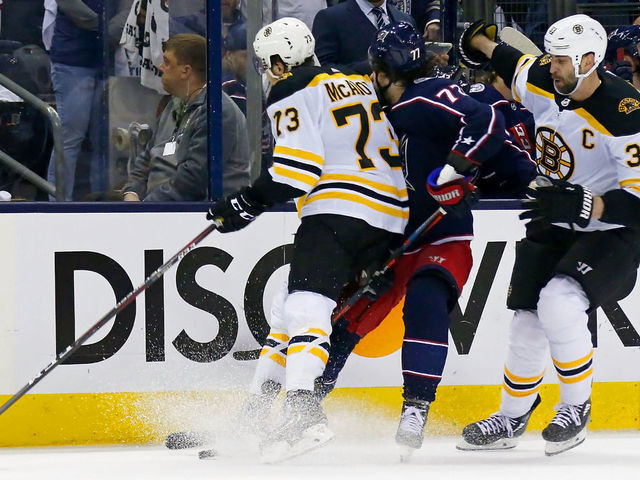 COLUMBUS, OH - MAY 6: Charlie McAvoy #73 of the Boston Bruins checks Josh Anderson #77 of the Columbus Blue Jackets in the head during the second period in Game Six of the Eastern Conference Second Round during the 2019 NHL Stanley Cup Playoffs on May 6, 2019 at Nationwide Arena in Columbus, Ohio. McAvoy was called for an illegal check to the head.