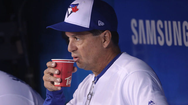 TORONTO, ON - APRIL 23: Manager Charlie Montoyo #25 of the Toronto Blue Jays drinks a Tim Hortons coffee in the dugout shortly before the start of MLB game action against the San Francisco Giants Rogers Centre on April 23, 2019 in Toronto, Canada.