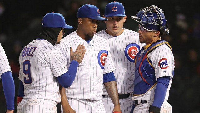 CHICAGO, ILLINOIS - MAY 06: Second from left Pedro Strop #46 of the Chicago Cubs is comforted by teammates after he gave up a walk to Rosell Herrera #5 of the Miami Marlins and a run and before being pulled in the ninth inning at Wrigley Field on May 06, 2019 in Chicago, Illinois.