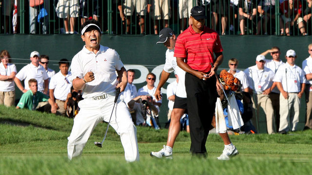 CHASKA, MN - AUGUST 16: (L-R) Y.E. Yang of South Korea celebrates a birdie putt on the 18th green alongside Tiger Woods during the final round of the 91st PGA Championship at Hazeltine National Golf Club on August 16, 2009 in Chaska, Minnesota.