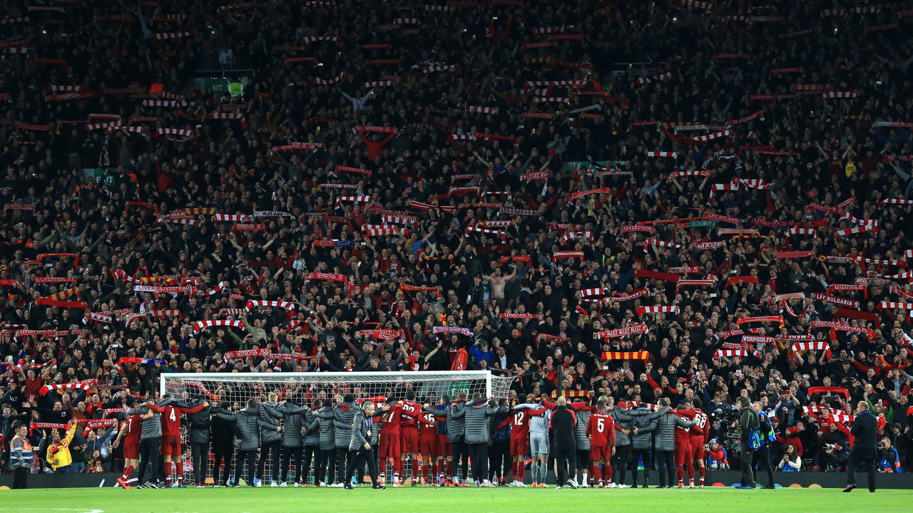 LIVERPOOL, ENGLAND - MAY 07: Liverpool fans in The Kop hold their scarves aloft as their players celebrate their victory after the UEFA Champions League Semi Final second leg match between Liverpool and FC Barcelona at Anfield on May 7, 2019 in Liverpool, England.