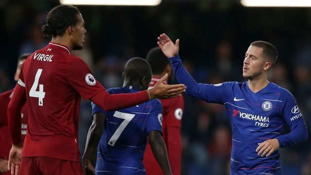 Liverpool's Dutch defender Virgil van Dijk (L) and Chelsea's Belgian midfielder Eden Hazard shake hands after the English Premier League football match between Chelsea and Liverpool at Stamford Bridge in London on September 29, 2018.