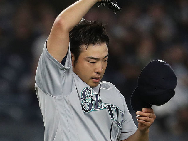 NEW YORK, NEW YORK - MAY 08: Yusei Kikuchi #18 of the Seattle Mariners reacts after giving up a hit in the sixth inning by Mike Tauchman #39 of the New York Yankees during their game at Yankee Stadium on May 08, 2019 in New York City.