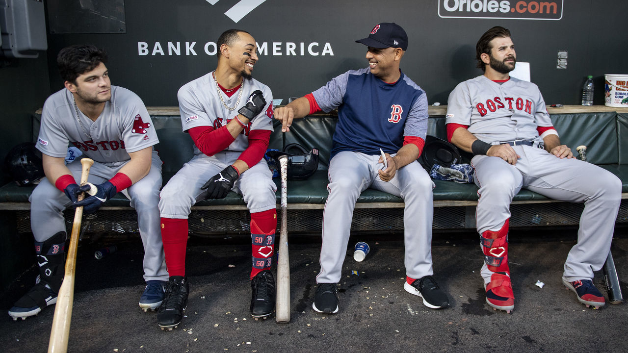 BALTIMORE, MD - MAY 7: Andrew Benintendi #16, Mookie Betts #50, manager Alex Cora, and Mitch Moreland #18 of the Boston Red Sox react in the dugout before a game against the Baltimore Orioles on May 7, 2019 at Oriole Park at Camden Yards in Baltimore, Maryland.
