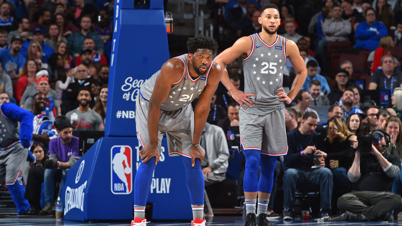 PHILADELPHIA, PA - DECEMBER 14: Joel Embiid #21 and Ben Simmons #25 of the Philadelphia 76ers look on during a game against the Indiana Pacers on December 14, 2018 at the Wells Fargo Center in Philadelphia, Pennsylvania NOTE TO USER: User expressly acknowledges and agrees that, by downloading and/or using this Photograph, user is consenting to the terms and conditions of the Getty Images License Agreement. Mandatory Copyright Notice: Copyright 2018 NBAE