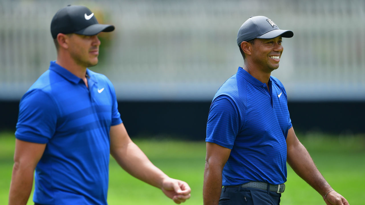 ST LOUIS, MO - AUGUST 08: Brooks Koepka and Tiger Woods of the United States walk together during a practice round prior to the 2018 PGA Championship at Bellerive Country Club on August 8, 2018 in St Louis, Missouri.