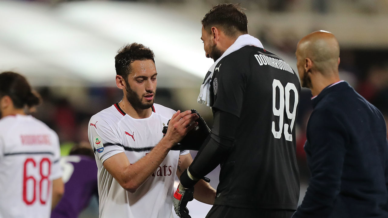 FLORENCE, ITALY - MAY 11: Hakan Calhanoglu and Gianluigi Donnarumma of AC Milan celebrates the victory after the Serie A match between ACF Fiorentina and AC Milan at Stadio Artemio Franchi on May 11, 2019 in Florence, Italy.
