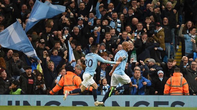 Manchester City's Belgian defender Vincent Kompany (R) celebrates scoring the opening goal during the English Premier League football match between Manchester City and Leicester City at the Etihad Stadium in Manchester, north west England, on May 6, 2019.