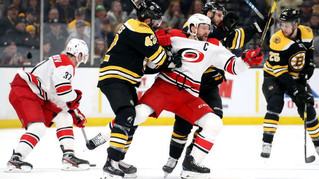 BOSTON, MASSACHUSETTS - MAY 12: David Backes #42 of the Boston Bruins checks Justin Williams #14 of the Carolina Hurricanes during the first period in Game Two of the Eastern Conference Final during the 2019 NHL Stanley Cup Playoffs at TD Garden on May 12, 2019 in Boston, Massachusetts.