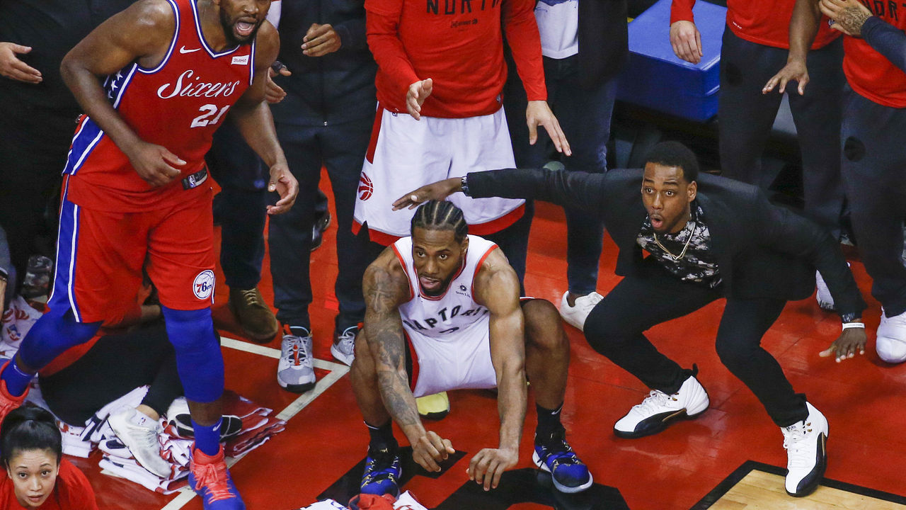 TORONTO, ON - MAY 12: Philadelphia 76ers center Joel Embiid (21) watches from the corner as Toronto Raptors forward Kawhi Leonard (2) squats down and sticks out his tongue waiting for the ball to drop for Raptors to win. Toronto Raptors vs Philadelphia 76ers in2nd half action of Round 2, Game 7 of NBA playoff play at Scotiabank Arena. . Toronto Star/Rick Madonik (Rick Madonik/Toronto Star via Getty Images)