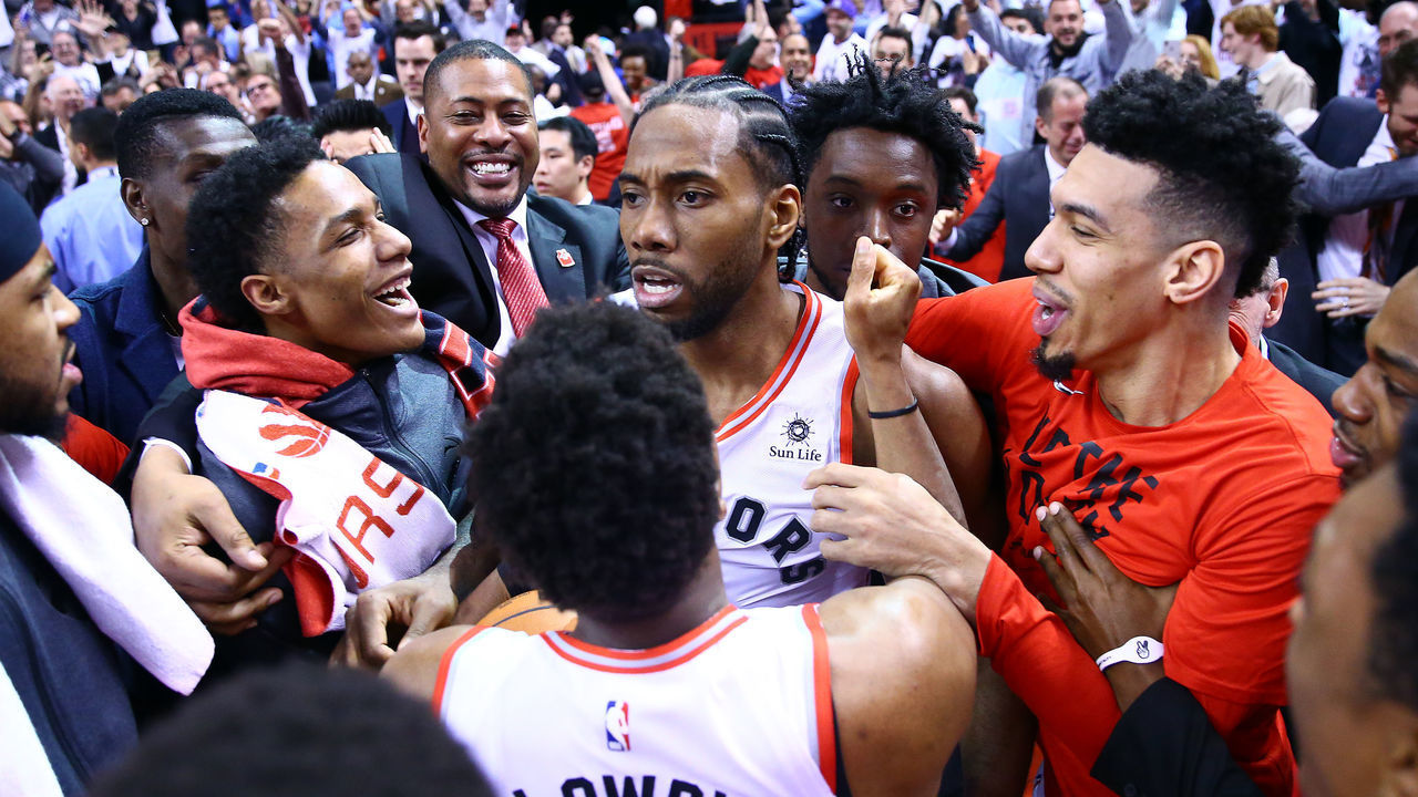 TORONTO, ON - MAY 12: Kawhi Leonard #2 of the Toronto Raptors celebrates with teammates after sinking a buzzer beater to win Game Seven of the second round of the 2019 NBA Playoffs against the Philadelphia 76ers at Scotiabank Arena on May 12, 2019 in Toronto, Canada.