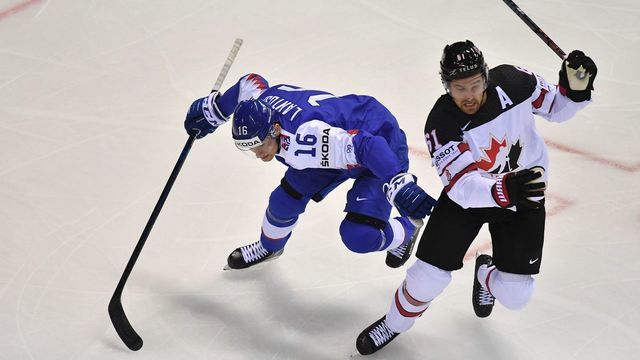 Slovakia's forward Robert Lantosi (L) and Canada's forward Mark Stone vie vie for the puck during the IIHF Men's Ice Hockey World Championships Group A match between Slovakia and Canada on May 13, 2019 in Kosice, Slovakia.
