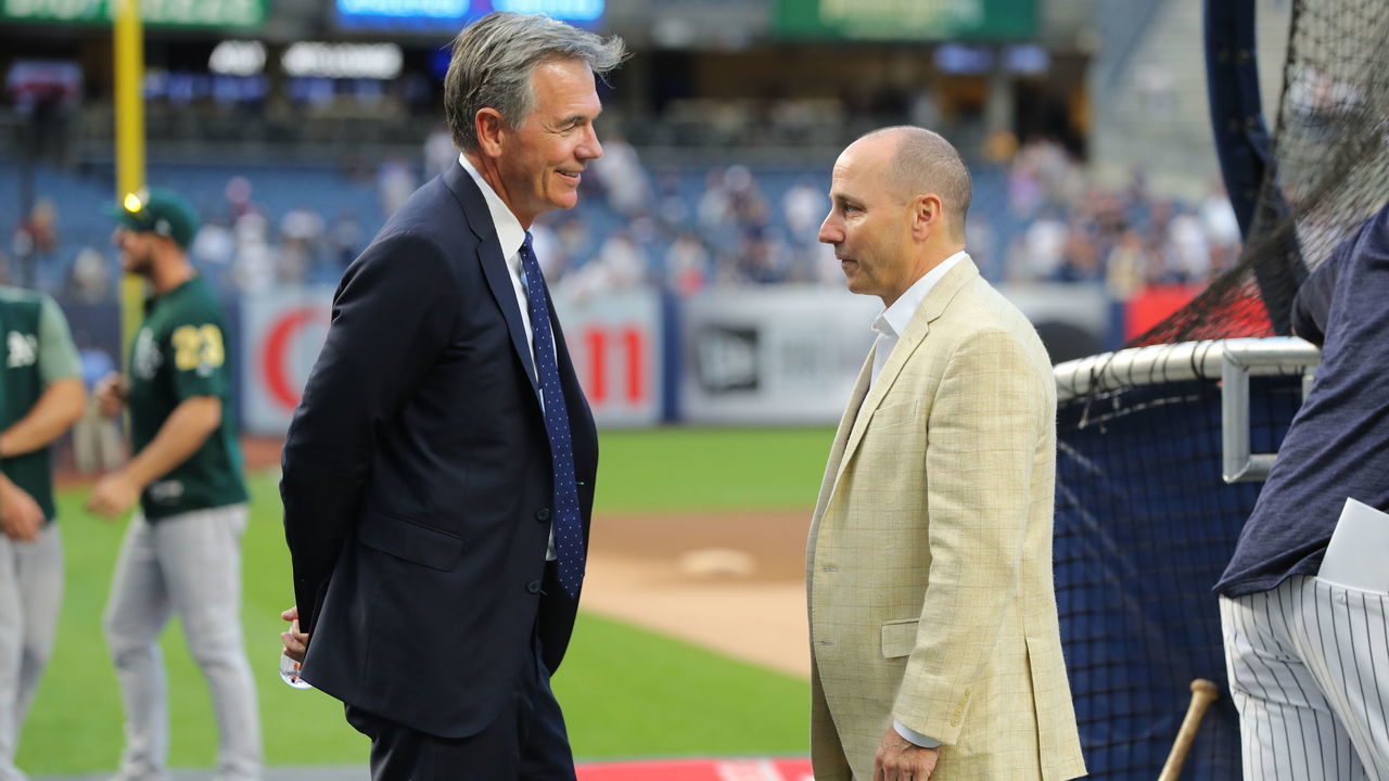 NEW YORK, NY - OCTOBER 3: Billy Beane, General Manager of the Oakland Athletics, and Brian Cashman, General Manager of the New York Yankees, chat before the American League Wild Card game at Yankee Stadium on Wednesday, October 3, 2018 in the Bronx borough of New York City.
