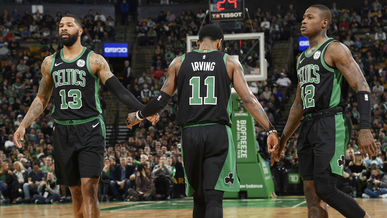 BOSTON, MA - MARCH 24: Marcus Morris #13 Kyrie Irving #11 and Terry Rozier #12 of the Boston Celtics high five against the San Antonio Spurs on March 24, 2019 at the TD Garden in Boston, Massachusetts. Mandatory Copyright Notice: Copyright 2019 NBAE
