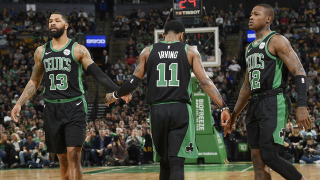 BOSTON, MA - MARCH 24: Marcus Morris #13 Kyrie Irving #11 and Terry Rozier #12 of the Boston Celtics high five against the San Antonio Spurs on March 24, 2019 at the TD Garden in Boston, Massachusetts. Mandatory Copyright Notice: Copyright 2019 NBAE